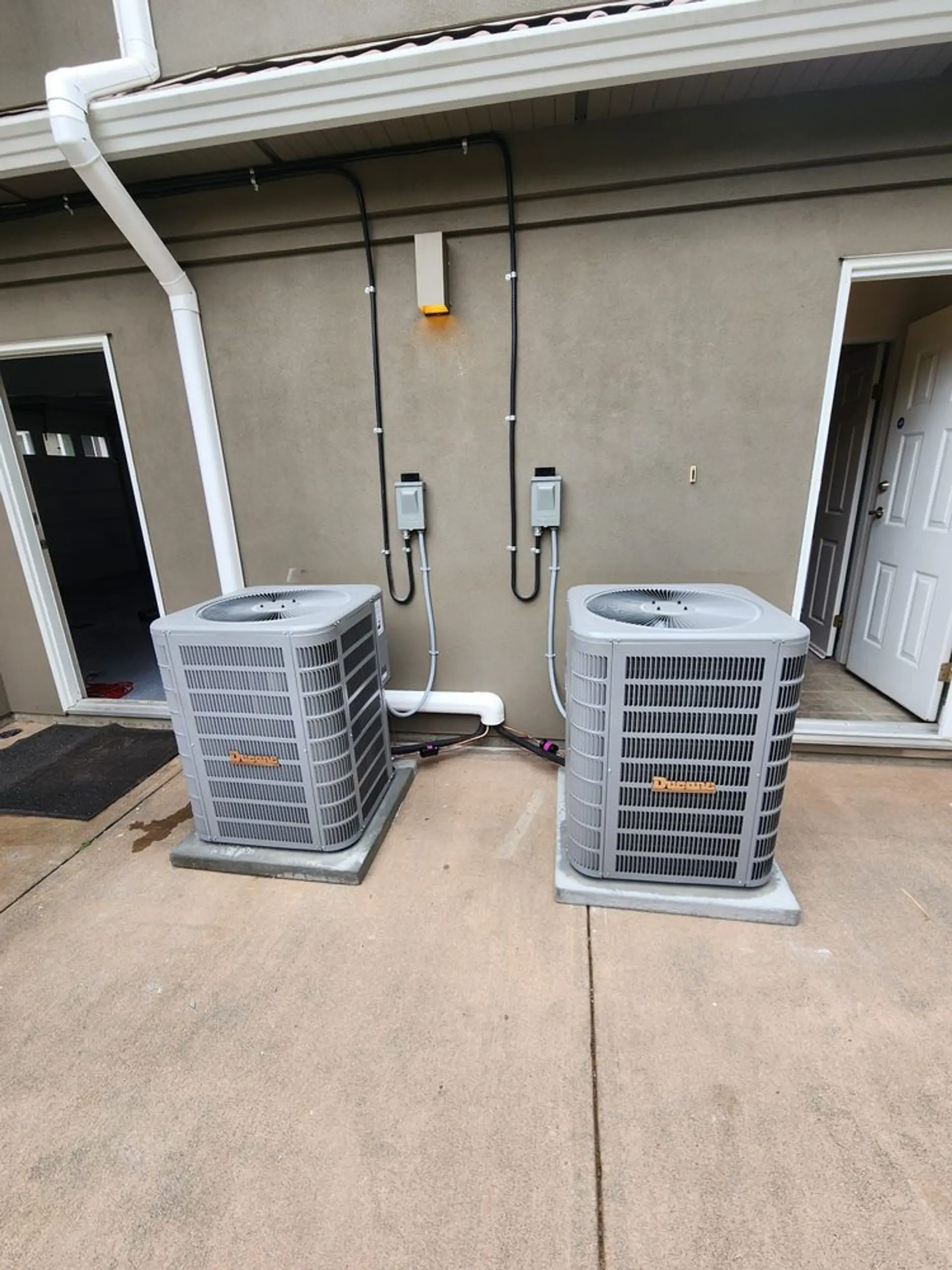 Dual outdoor AC condenser units installed